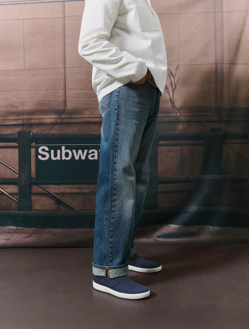 Man standing posing with ECCO Soft 7 Slip-Ons in blue
