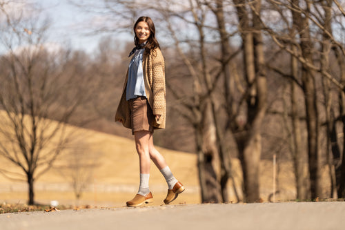Woman in the woods wearing Dansko Clogs